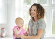 Woman sitting and holding baby
